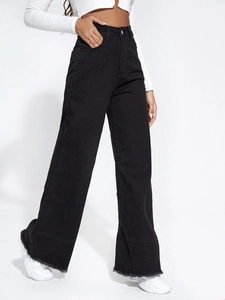 Detail of high waisted black wide leg jeans featuring raw hem edges and loose denim fit