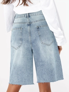 Rear view of light blue denim Bermuda shorts with raw edges and classic back pockets