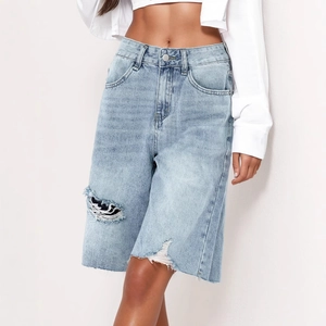 Women's light blue high-waisted denim shorts with distressed rips and frayed hem details