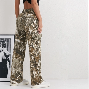 Detail of high waist camo cargo pants featuring large side pockets and bark print pattern