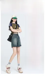 Detail of high waist denim shorts featuring a vintage wash and A-line silhouette for women