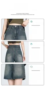 Detail view of high waist denim shorts featuring vintage wash texture and back shield pockets