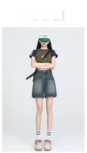 Retro high-waisted dark blue denim shorts styled with olive green star print t-shirt