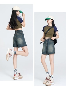 Detail of high-waisted denim shorts and retro star print raglan cropped t-shirt set