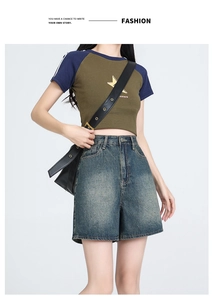 Close-up of high-waist washed denim shorts with vintage star print raglan sleeve top