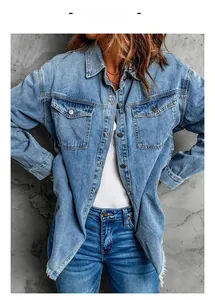 Detail of blue denim shirt jacket featuring chest pockets and frayed raw hem fringe