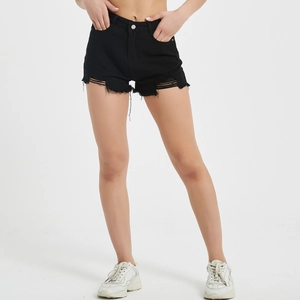 Detailed view of high-waisted black denim shorts featuring distressed rips and raw fringe hem