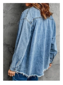 Detailed back view of loose vintage denim jacket with frayed hem and dropped shoulders