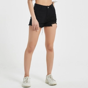 Detail view of black high-waisted denim shorts featuring raw hem and distressed leg finish