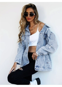Close-up of light wash distressed denim jacket featuring metal buttons and ripped details