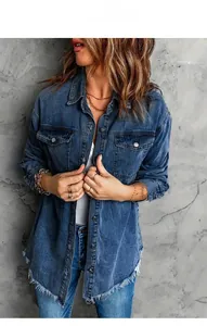 Detail of vintage blue denim jacket with frayed edges and classic flap pockets