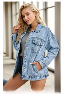 Detail of light blue washed denim jacket with metal buttons and flap chest pockets