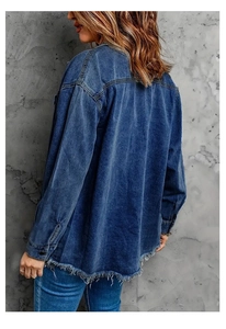 Macro shot of the oversized blue denim jacket featuring a distinct raw hem back design