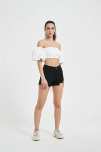Full view of women's white puff sleeve crop top with black high waist frayed denim shorts