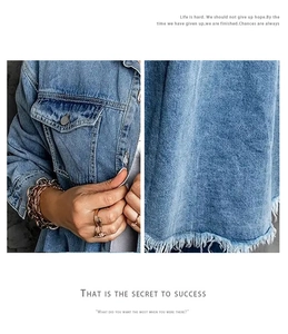 Detailed view of frayed raw hem and chest pockets on this vintage blue denim jacket