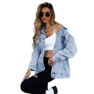 Light blue oversized denim jacket with distressed ripped details and metallic buttons