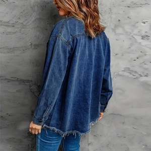 Vintage oversized mid-blue denim jacket for women with distressed fringe hem and drop shoulders