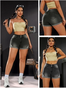 Detail of high waist grey denim shorts with triple button closure and mustard crop top
