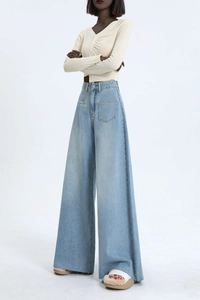 Detailed macro view of light blue washed denim jeans featuring large front patch pockets