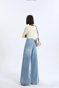 Rear view of high-waisted wide-leg denim jeans with raw hem and back pocket details