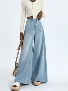 Detail of high waist light blue wide leg jeans with patch pockets and raw hem edges