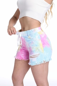 Macro view of high waist tie-dye denim shorts featuring elastic drawstring and frayed hem