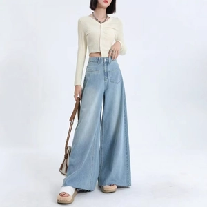 Women's light blue high-waisted wide-leg jeans with retro wash and raw frayed hems