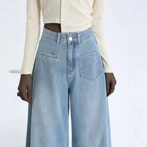 Women's high waist wide leg light blue denim jeans with asymmetrical pocket design