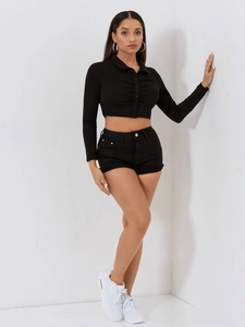 Front view of multi-pocket denim shorts and a button-up cropped polo top in black