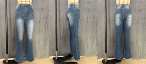 Detail of high waisted flared jeans with side button hem and vintage washed finish