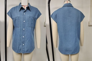 Detail of blue denim sleeveless shirt with front buttons and chest pockets