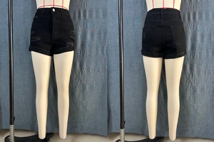 Front and back view of black high waisted denim shorts with ripped details and raw hem