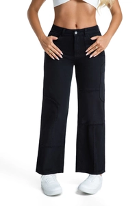 Detail of high-waist black wide-leg jeans featuring raw edge patchwork and contrast stitching