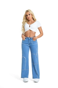 Detail of wide-leg patchwork denim jeans paired with white cutout crop top on model
