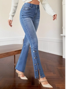 Women's vintage high waist flared jeans with side metal button slit detail and blue wash
