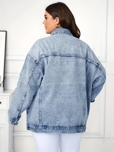 Detail of light blue denim jacket featuring classic wash and relaxed oversized fit