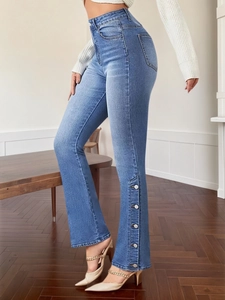 Slim fit light blue flare jeans with decorative metal buttons at the hem for women
