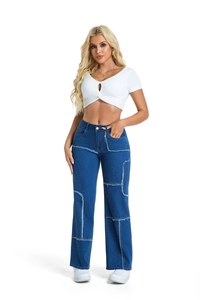 Detail of high-waisted blue jeans featuring patchwork design and distressed frayed edges