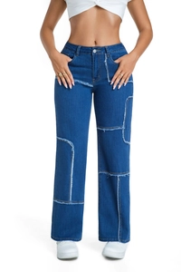 Detail of dark blue wide-leg jeans with deconstructed patchwork and frayed stitching details