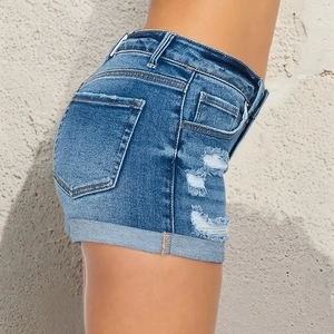 Women's blue denim shorts with ripped details and rolled cuffs shown from side view