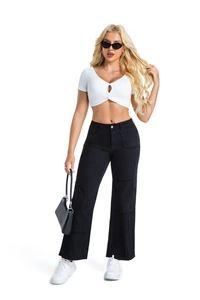 Full-body shot of wide-leg black denim jeans with unique patchwork details on a female model