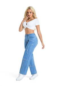 Detail of high waisted patchwork wide leg jeans with distressed raw edges and blue denim