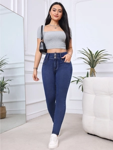 Detail of high-waisted dark blue skinny jeans with triple-button closure and slim fit