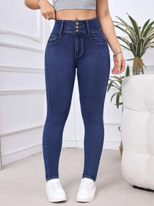 Detail view of high-waist skinny jeans featuring a stylish triple-button closure and slim fit