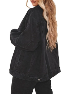 Detail view of oversized black washed denim jacket showing relaxed fit and silver buttons
