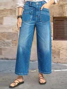Detail of high waisted wide leg jeans in mid-blue wash featuring large front patch pockets