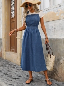 Blue denim overall dress with large front pocket and pleated waist for casual style