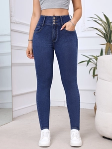Detail of high waist skinny jeans in dark blue with triple button closure and stitching