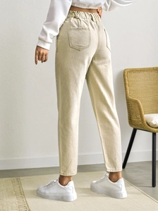 Detail of high-waist straight-leg pants featuring an elastic waistband and back pockets