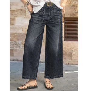Detail of high-waisted wide-leg jeans with large patch pockets and frayed raw hems
